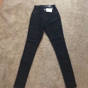 A pair of black Fashion Nova Jeans